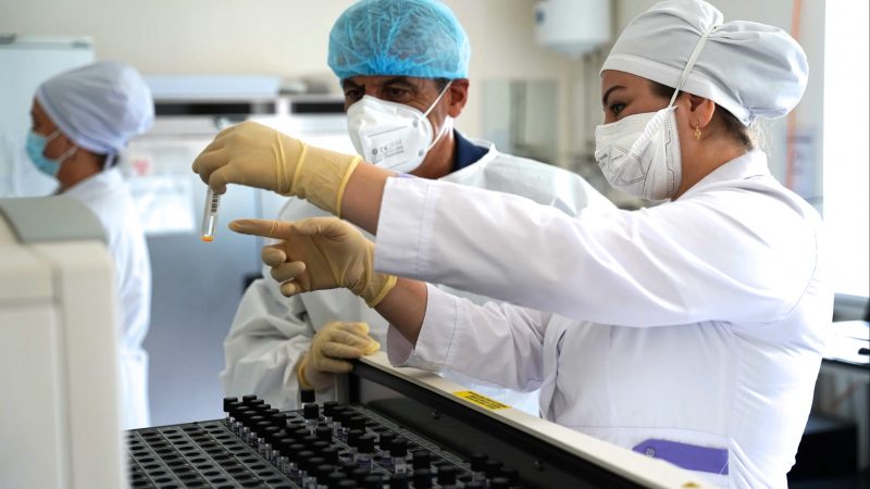 Makhmatlatif Karimov, diagnostics and laboratory advisor for the USAID End TB Tajikistan Activity, and Lola Sharipova, laboratory technicians for the Kulob Regional TB Center Laboratory, check mycobacteria growth indicator tubes while conducting a rapid tuberculosis testing network assessment in Kulob, Tajikistan. Photo credit: Masum Vohidov for FHI 360